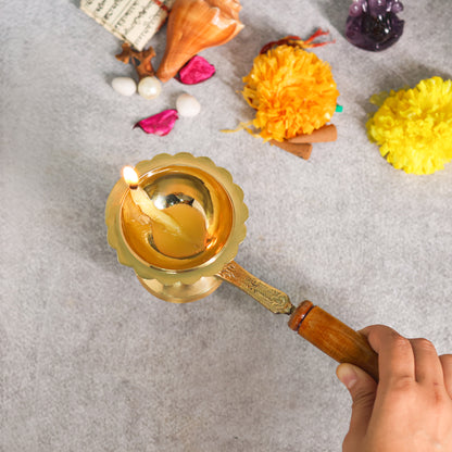 Brass diya with wood handle  